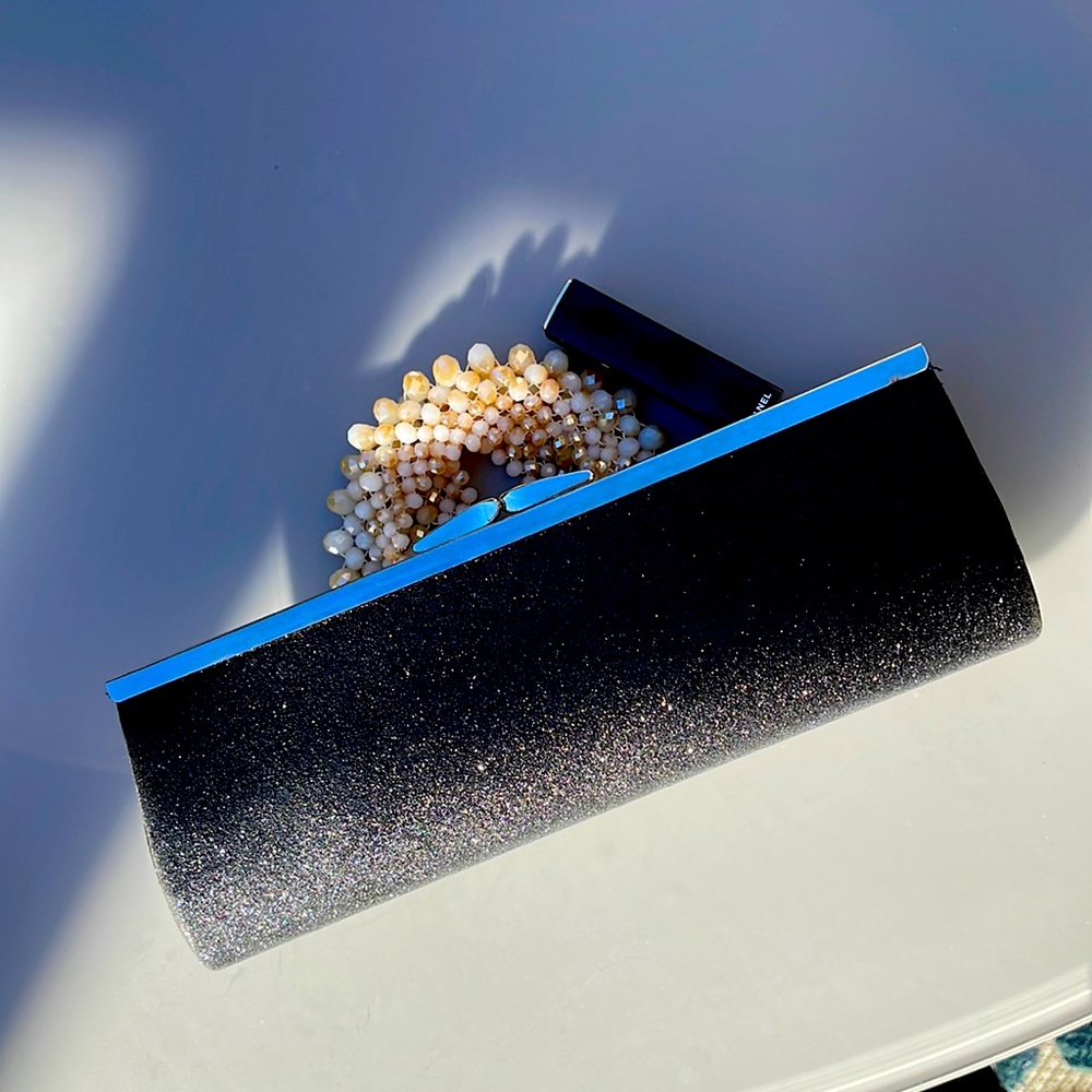Long narrow glitter clutch. Black with silver glitter & closure.